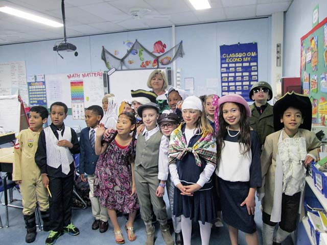 April Harper’s third-grade class at Ramstein Intermediate School poses for a photo during their living wax museum event honoring America’s heroes May 27. Students selected a hero, researched them and wrote reports. They then dressed in costume as their hero and pretended to be wax figures at the event. Museum visitors pushed a button and the wax figures came to life answering questions in character. 