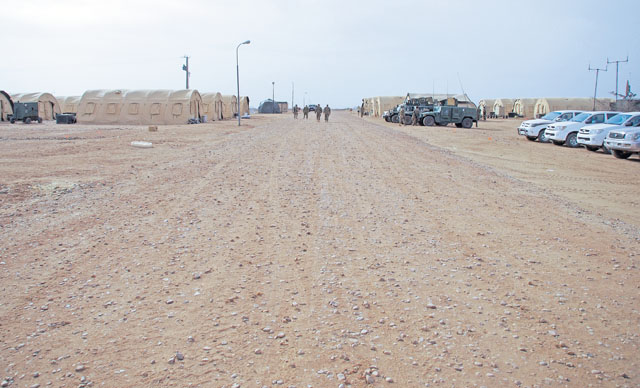 Photo by Jeffrey McGovernAirmen walk down the main strip of a newly established base April 27 in Africa. The mission of the 435th Contingency Response Group is to construct bases out of bare strips of land. This deployment showcased the CRGs capabilities.