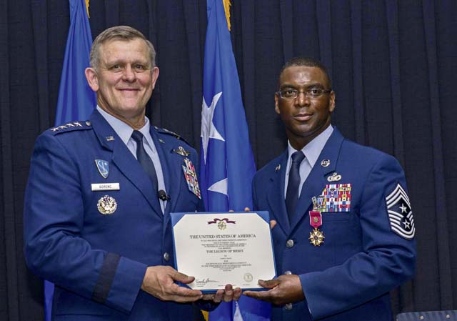 Photo by Airman 1st Class Tryphena MayhughGen. Frank Gorenc, U.S. Air Forces in Europe and U.S. Air Forces Africa commander (left), presents Chief Master Sgt. James E. Davis, USAFE-AFAFRICA command chief, a certificate for the Legion of Merit during Davis’ retirement ceremony June 13 on Ramstein. Davis entered in the Air Force in 1986, served for 30 years and has been stationed at Ramstein since August 2013.