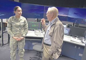 Retired Chief Master Sgt. Kenneth Andrews speaks with Airman 1st Class Paige Goulette, air traffic control apprentice, May 24 in the air traffic control simulator on Ramstein. Andrews entered the Air Force in 1947 during the same year air traffic control became an independent service.