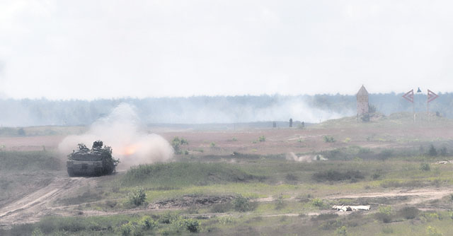 An M1 Abrams tank fires and moves forward with a group of tanks as part of a live-fire event during exercise Anakonda 2016 June 16 in Poland.