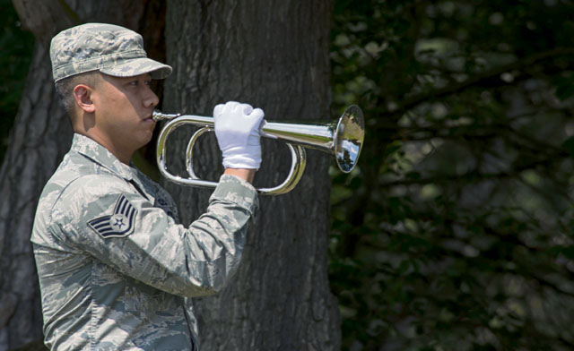 Staff Sgt. Srun Sookmeewiriya, 313th Expeditionary Operations Support Squadron senior controller, plays Taps on the bugle during a funeral ceremony demonstration as part of the Air Education and Training Command’s Class 5 Basic Protocol, Honors and Ceremonies Course graduation ceremony June 9 on Ramstein. 