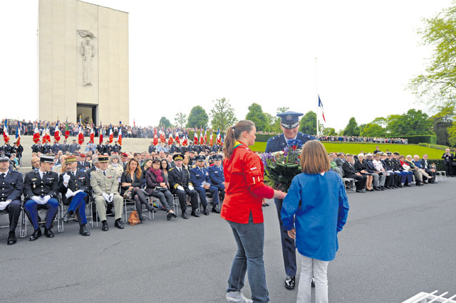 French Girl Scout members present a wreath to Brig. Gen. Jon Thomas, 86th Airlift Wing commander, during a Memorial Day ceremony May 29 at Lorraine American Cemetery and Memorial in St. Avold, France.