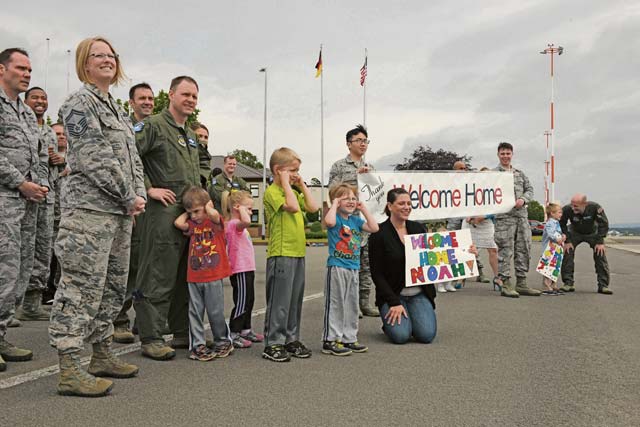 Family members and colleagues of Airmen returning from a deployment await their arrival June 1 on Ramstein. The family members welcomed the Airmen as they disembarked from their C-20H Gulfstream IV aircraft.
