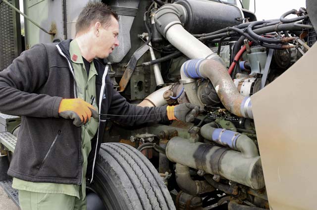 A driver performs preventive maintenance checks and services on his vehicle after receiving his orders of the day May 18. The 6966th Transportation Truck Terminal recently recognized eight drivers for having completed a million or more accident-free miles, an accomplishment which takes countless hours of maintenance and preparation in addition to driving.