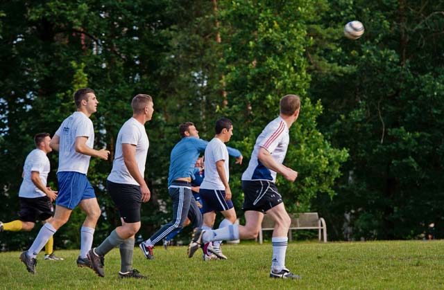 Soccer players run down the field after their team’s goalkeeper throws the ball during an intramural soccer season finals game June 29, 2016, at Ramstein Air Base.