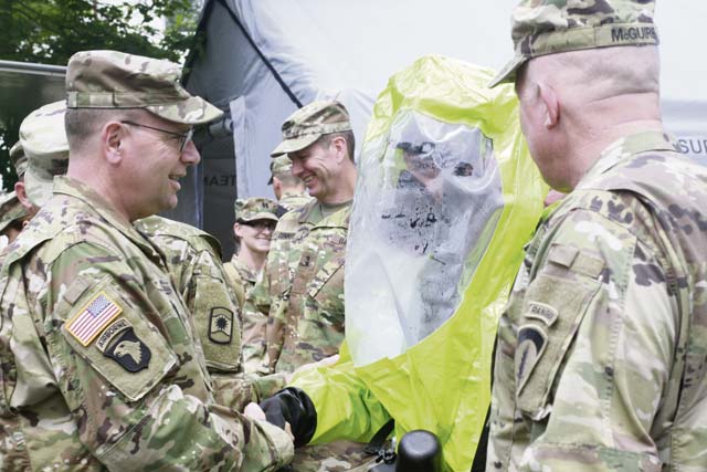 Photo by Sgt. Daniel J. FriedbergLt. Gen. Frederick B. Hodges, U.S. Army Europe commanding general, shakes hands with a Soldier in a chemical protective suit during a visit July 9 on Daenner Kaserne. Hodges emphasized the U.S. Army and Army Reserve's strategic role in Europe against both conventional and unconventional threats.