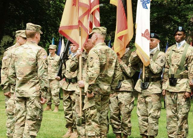 Photo by Staff Sgt. Betty Y. Boomer Command Sgt. Maj. Stanley O. Richards passes organizational colors to Maj. Gen. Duane A. Gamble, the 21st TSC commanding general, as Command Sgt. Maj. Alberto Delgado (left), the new 21st Theater Sustainment Command senior enlisted leader, prepares to accept the banner during a change of responsibility ceremony held July 8 at Panzer Field. Delgado, a combat-tested logistician who served most recently as the Army Material Command operations and logistics sergeant major, replaced Richards, who served as senior enlisted leader of the 405th Army Field Support Brigade for the past two years as well as the TSC’s top enlisted man since mid-March, during the afternoon ceremony. 