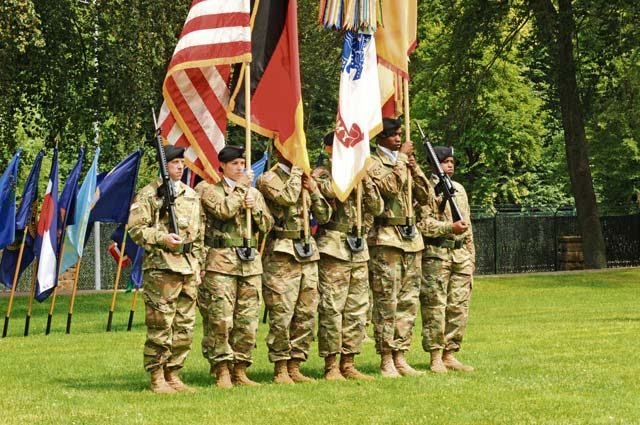 Photo by Staff Sgt. Betty Y. Boomer A color guard representing the 21st Theater Sustainment Command bears organizational, service and national banners during the change of responsibility ceremony held July 8 at Panzer Field. Command Sgt. Maj. Alberto Delgado, a combat-tested logistician who served most recently as the Army Material Command operations and logistics sergeant major, replaced Command Sgt. Maj. Stanley O. Richards, who served as senior enlisted leader of the 405th Army Field Support Brigade for the past two years as well as the TSC’s top enlisted man since mid-March, during the afternoon ceremony. 