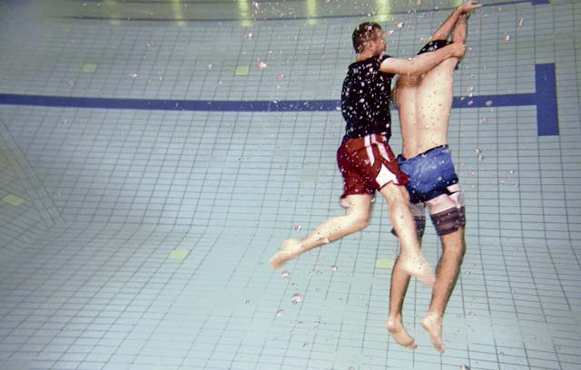 Andrew Broadwater, Ramstein Aquatic Center supervisory recreation specialist lifeguard and lifeguard course instructor, demonstrates a rescue of a victim on the bottom of the pool July 14 on Ramstein. The lifeguard course taught students how to perform rescues for victims that are conscious or unconscious, face up or face down, and on the surface or on the bottom of the pool.