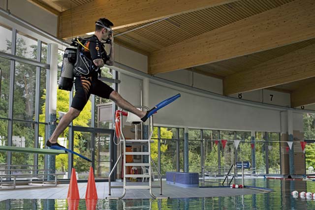 A student in the Ramstein Aquatic Center’s Professional Association of Diving Instructors Open Water Certification class jumps into a pool July 7 on Ramstein. Students must undergo four days of classroom and hands-on training in the pool and two days in open water at a lake to receive their certificate.