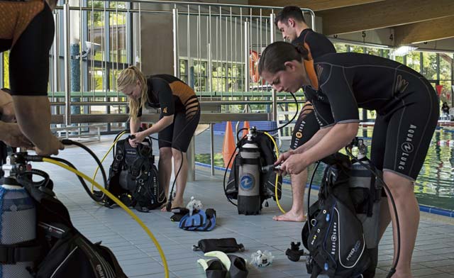 Students of the Ramstein Aquatic Center’s Professional Association of Diving Instructors Open Water Certification class prep their gear July 6 on Ramstein.
