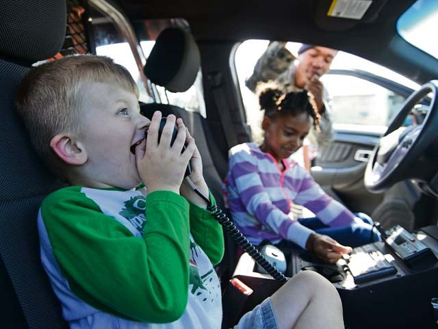 Children familiarize themselves with the features of an 86th Security Forces Squadron vehicle during a block party Aug. 5 on Ramstein. The Ramstein Enlisted Club block party featured static displays from the 86 SFS and the 86th Civil Engineer Squadron fire department, free food for club members, face painting, bouncy castles and toy pony rides.