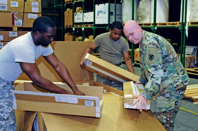 Soldiers from the 21st Theater Sustainment Command help unload a shipment of weapons July 27 at the Kaiserslautern Army Depot. The new weapons consisted mainly of new M4 rifles.