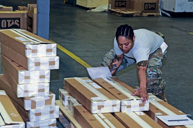 Staff Sgt. Roneece Coleman, 405th Army Field Support Brigade supply sergeant, helps unload a shipment of weapons July 27 at the Kaiserslautern Army Depot.