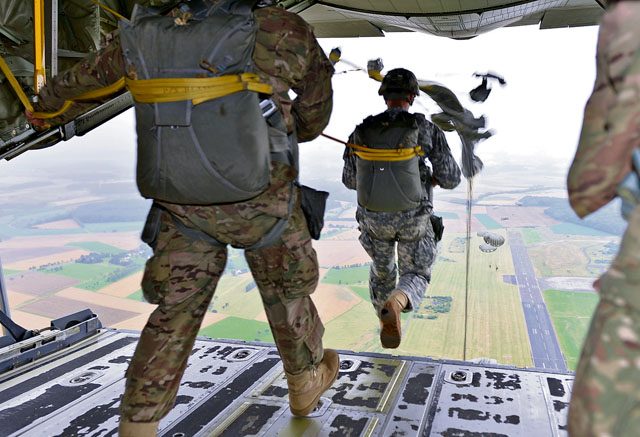 International Jump Week participants jump out of a C-130J Super Hercules July 27 at Bitburg Airfield, Germany. Multinational service members attended the biannual event to build relations and share knowledge.