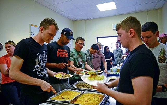 Airmen partake in a meal together July 15 on Ramstein. The free weekly dinner for Airmen E-4 and below is part of the ministry of Club 7.