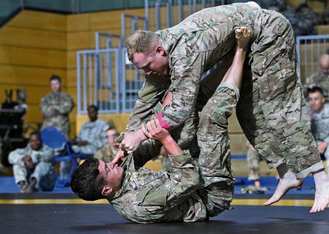 Photos by Staff Sgt. Frank Brown Jr. First Lt. Kendall Ward, 173rd Infantry Brigade Combat Team (Airborne) and 2016 Best Officer Warrior, grapples with 1st Lt. Ethan Klausner, 2nd Cavalry Regiment and category runner-up, during a combatives tournament Aug. 11, the final day of the European Best Warrior Competition, at the Grafenwoehr Training Area, Germany. The U.S. Army Europe and 21st Theater Sustainment Command senior enlisted leaders unveiled the region’s Best Warriors during an award ceremony held later in the day at the Tower Barracks Physical Fitness Center.
