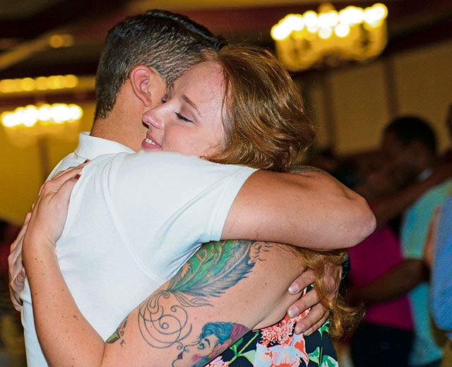 Staff Sgt. Joy Martz, 603rd Air Operations Center NCO in charge of command post training, embraces her fiance, Staff Sgt. Joe Ferrara, 721st Aerial Port Squadron air transportation specialist, at the end of a marriage seminar Aug. 6 on Ramstein. Gary Chapman, marriage counselor and author of “The 5 Love Languages” book series, spoke to KMC couples on how to enrich their life with their spouses.