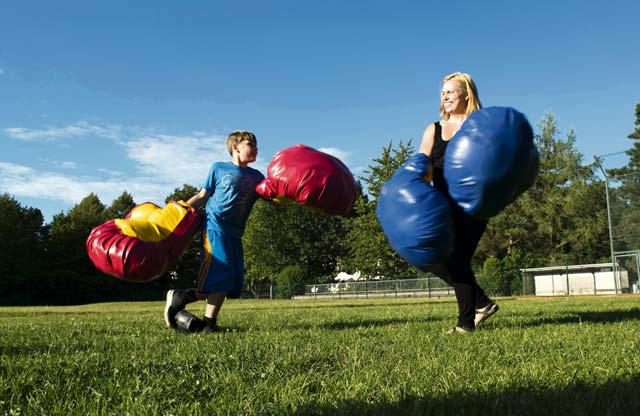A Kaiserslautern Military Community member and her son box during the Ramstein and Vogelweh Community Center’s Olympic Family Night Aug. 22, 2016, at Ramstein Air Base. To earn a medal, children also participated in sumo wrestling, basketball, a three-legged race, a potato sack race and a “ski race.”