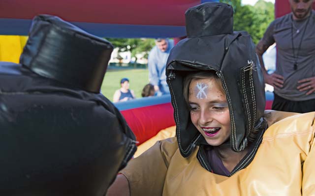 A child sumo wrestles during the Ramstein and Vogelweh Community Center’s Olympic Family Night Aug. 22, 2016, at Ramstein Air Base. The event was open to all KMC members. Families of deployed members and children under three attended for free.
