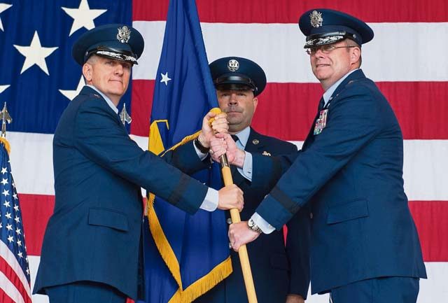 Photo by Airman 1st Class Lane Plummer Lt. Gen. Timothy M. Ray, 3rd Air Force commander (left), passes the guidon to Brig. Gen. Richard G. Moore during the 86th Airlift Wing change of command ceremony as Chief Master Sgt. Aaron D. Bennett, new 86 AW command chief, looks on Aug. 17 on Ramstein. The passing of a wing's guidon symbolizes a transfer of command.