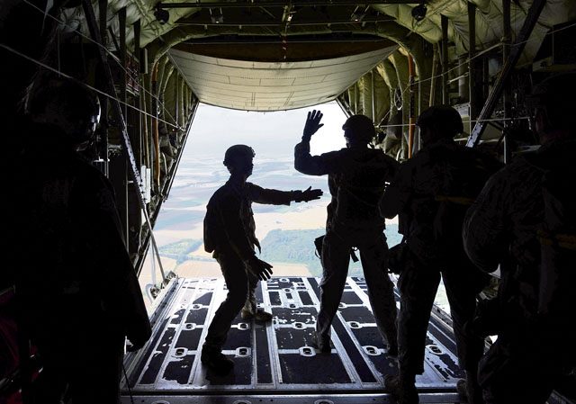 Photo by Airman First Class Joshua Magbanua Paratroopers prepare to jump from a C-130J Super Hercules July 27 over Bitburg Airfield, Germany. The U.S. and seven other allied nations conducted four days of high-altitude, low-opening and static-line jumps during International Jump Week.