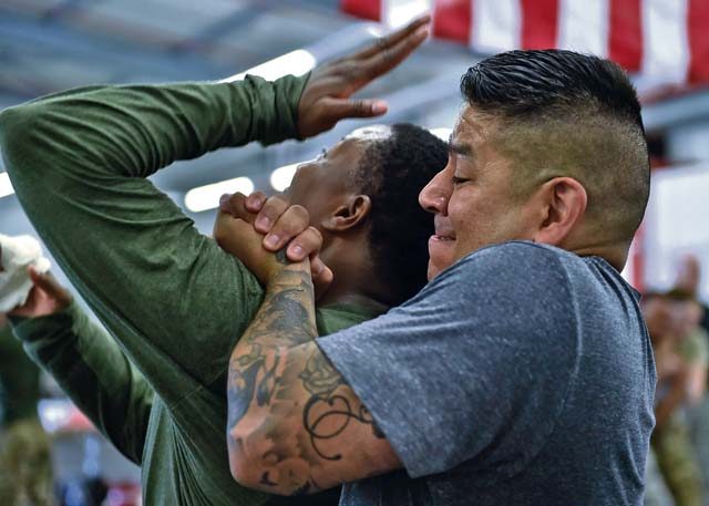 Master Sgt. Anthony Sanchez, 569th U.S. Forces Police Squadron NCO in charge of training, holds Staff Sgt. LaDonna Winston, 435th Security Forces Squadron ground regional training center instructor, in a tight grip Aug. 4 on Ramstein. During the course, students practiced different techniques to be better prepared for an attack.