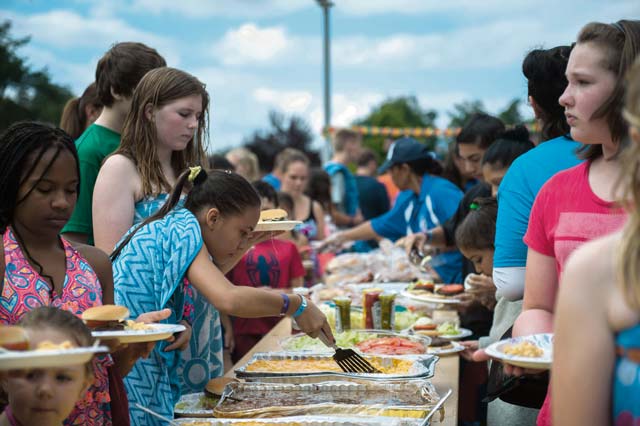 Photo by Airman 1st Class Lane T. Plummer  Families get food during a party for family members of deployed Airmen Aug. 12, 2016, at Ramstein Air Base. The event was held for family members of deployed Airmen around the Kaiserslautern Military Community to bring families closer through a variety of food and games.