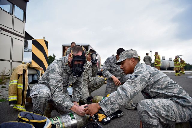 Photo by Senior Airman Damon Kasberg Brig. Gen. Jon T. Thomas, 86th Airlift Wing commander, puts on firefighter gear with the help of an Airman from the 786th Civil Engineering Squadron Sept. 18, 2015, on Ramstein. Thomas took an immersion tour around Ramstein to learn about Airmen’s jobs and discover different functions around base.