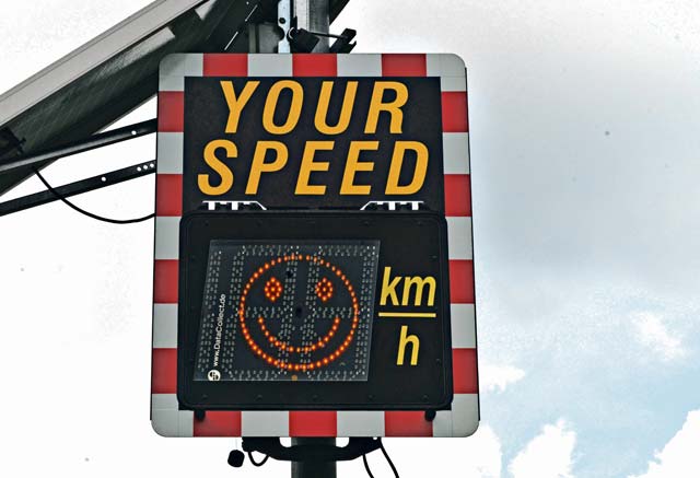 Photo by Airman 1st Class Joshua Magbanua A speed limit sign displays a happy face when motorists adhere to the speed limit at Ramstein Air Base. The 86th Airlift Wing Safety office advises motorists to exercise caution in school zones to avoid potential mishaps. 