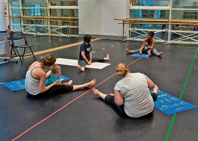 Students stretch before a Mommy and Me Yoga course hosted by the 86th Force Support Squadron Aug. 29 on Ramstein. Children participating with their mothers must be between the ages of 2 and 3 to take the class.