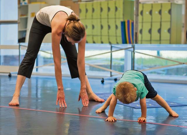 Jackson Parnell joins his mother, Brandy Parnell, in a cool-down stretch during the first Mommy and Me Yoga class Aug. 29 on Ramstein. The instructor incorporated nontraditional names for poses to keep the young children more engaged, as well as created an environment to promote a deeper mother-to-child bond.
