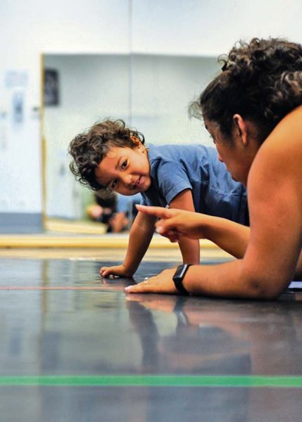 Roy Barrios watches his mother, Kadyzshea Barrios, during a Mommy and Me Yoga class Aug. 29 on Ramstein. The Mommy and Me Yoga course is offered every Monday.