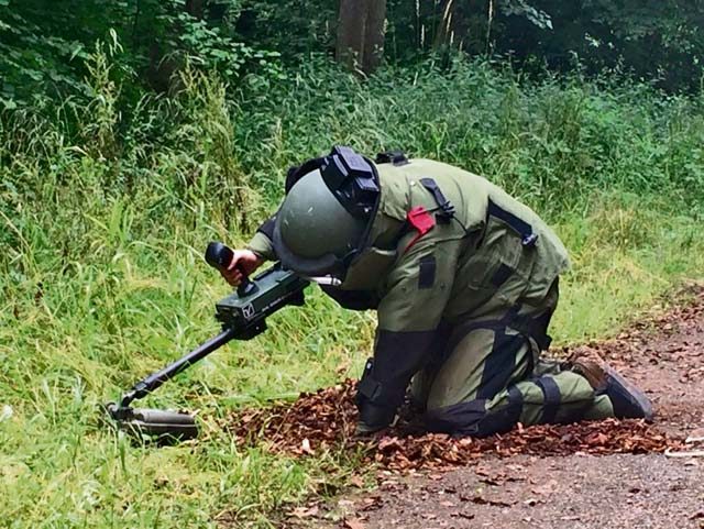 Photo by Lamont Hall Sgt. Peter Ebert, a team member assigned to 720th Ordnance Company (Explosive Ordnance Disposal) inspects a suspected improvised explosive device in a bomb suit. Ebert scans the area with a VMR2 hand held detector supplied by the Baumholder Counter Improvised Explosive Device Integration Cell July 27 in Baumholder. 