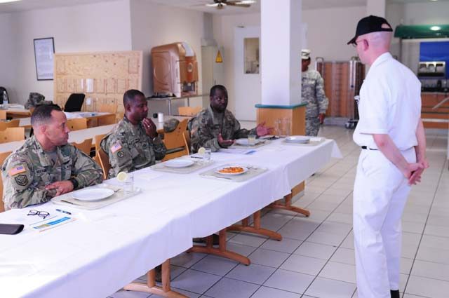 Photos by Pfc. Dashaad Boyd Sgt. Aaron Warren, 317th Mission Support Command cook, presents the dish he created for the Culinary Warrior of the Year cook-off competition Sep. 7 on Kleber Kaserne.