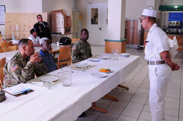 Pvt. Justin Quintana, 557th Area Support Medical Command cook, presents the dish he created for the Culinary Warrior of the Year cook-off competition Sep. 7 on Kleber Kaserne.