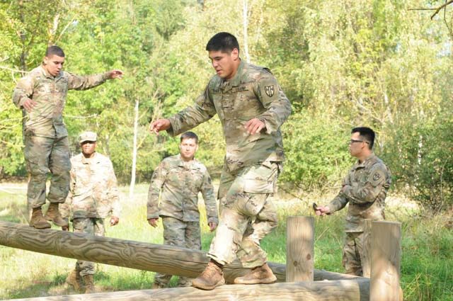 Soldiers from the 554th Military Police Company had to balance on the logs as part of an obstacle course during the Clifton Challenge Sept. 1 at Boeblingen Local Training Area, Germany. Soldiers participated in the Clifton Challenge to honor Cpl. Karen Clifton who died in Baghdad, Iraq, in 2007. 