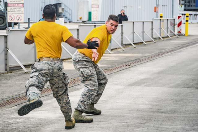 Senior Airman Gregory Foster tags Staff Sgt. Benjamin Patton, both 435th Contingency Response Squadron mobile aerial porters, during the relay run portion of the physical challenge obstacle course Sept. 17 on Ramstein.