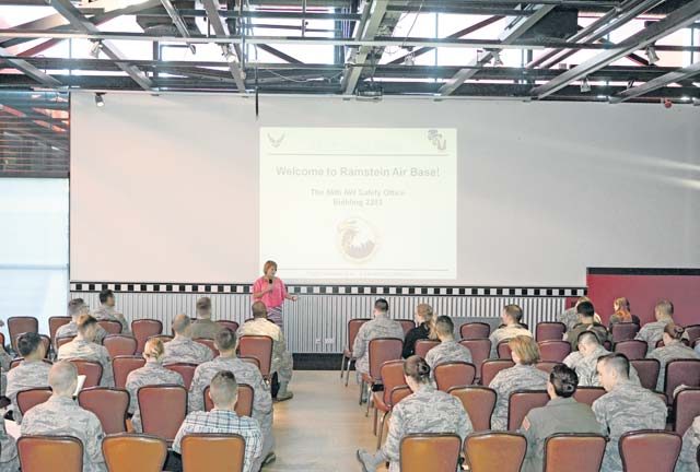 Kathy Keane, Airman and Family Readiness Center community readiness consultant, speaks to service members and their families during a base introduction brief Aug. 24 on Ramstein. Several base organizations brief newcomers on important community information such as housing, financial, legal and safety aspects as well as local culture. 