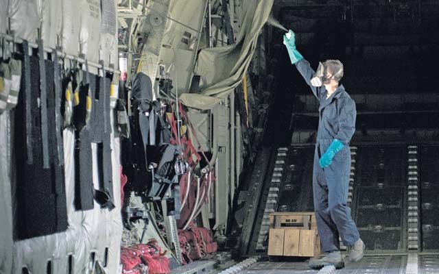 Airman 1st Class Christopher Jones, 786th Civil Engineer Squadron pest management specialist, sprays repellent in a C-130J Super Hercules to prevent the spread of the Zika virus Aug. 29 on Ramstein. The repellent prevents the spread of the virus by leaving behind a residue that kills mosquitos and other flying insects on contact.