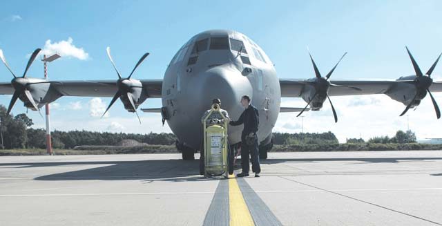 Staff Sgt. Antonio Gross (left) and Airman 1st Class Christopher Jones, 786th Civil Engineer Squadron pest management specialists, wait for the repellent to settle inside a C-130J Super Hercules to prevent the spread of the Zika virus Aug. 29 on Ramstein. After the repellent has settled for 30 minutes, the aircraft is aired out for an additional 30 minutes.