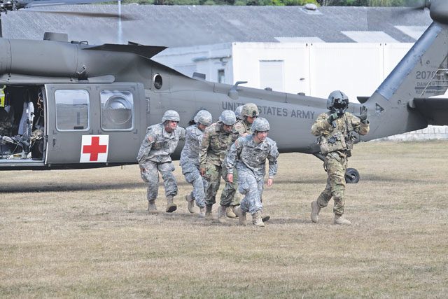 Seventh Mission Support Command Soldiers from the Medical Support Unit-Europe conduct medical evacuation training with the 1st Armored Division’s Combat Aviation Brigade Sept. 9 at NCO Field on Daenner Kaserne.