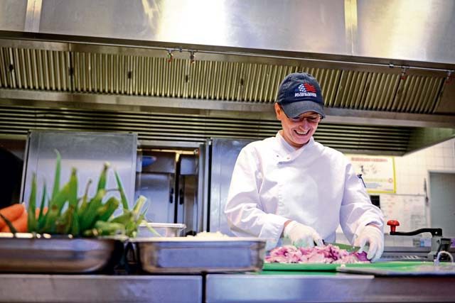 Adina Georgescu, Rheinland Inn dining facility cook, prepares vegetables Aug. 23 on Ramstein. The DFAC serves approximately 700 Airmen per day. 