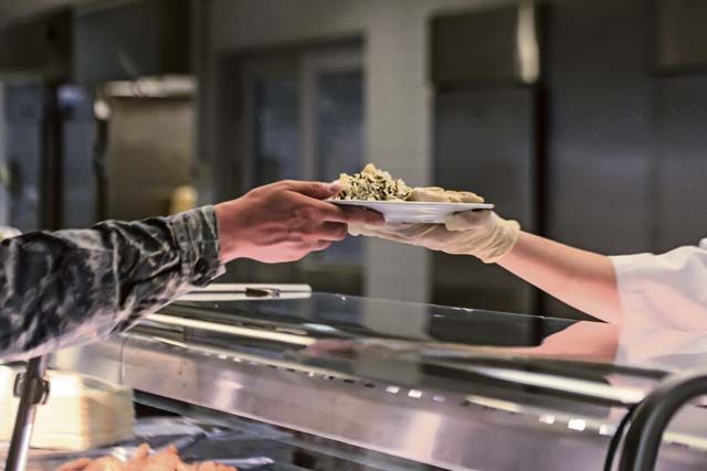 A food services Airman serves a customer at the Rheinland Inn Dining Facility Aug. 29 on Ramstein. The Rheinland Inn offers a wide variety of snacks, entrees, dessert and beverages.