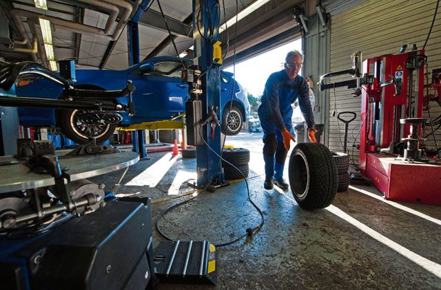 Retired Air Force Master Sgt. Greg Hermann, 86th Force Support Squadron Auto Hobby Shop tire technician, rolls one of his customer’s tires in for a tire inspection Oct. 5 on Ramstein. Hermann mans the tire shop alone and changes an average of 40 to 50 tires every day.