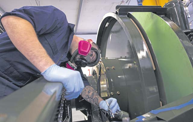 Staff Sgt. Kyle Morris, 435th Construction and Training Squadron aircraft arresting systems depot technician, checks his work while painting a BAK-12 aircraft arresting system Oct. 12 on Ramstein. Morris painted the arresting system to prevent corroding. Each system requires an overhaul every ten years, and the 435 CTS is the only squadron within U.S. Air Forces in Europe with the capability to do so.