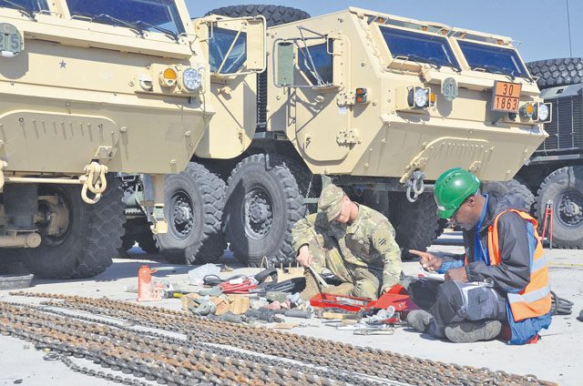 Private Rob Thorton, a construction equipment maintainer with 1st Armored Brigade Combat Team, 3rd Infantry Division, and Ron Jones, a contractor at Coleman Work Site, conduct a joint inventory and inspection of equipment Sept. 30 at the European Activity Set staging area. Instead of closing, Coleman was selected as U.S. Army Europe’s site for the EAS, where thousands of vehicles and pieces of equipment could receive depot-level maintenance and full reset, be staged and stored, and ultimately be issued back out to Army combat brigades rotating in and out of Europe.