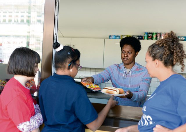 Airman 1st Class Jazmine Washington, 86th Medical Operations Squadron dental technician, serves food to students after an adaptive sports soccer game Sept. 22 on Vogelweh. Airmen came out to volunteer and help make the event run smoothly for the students participating.