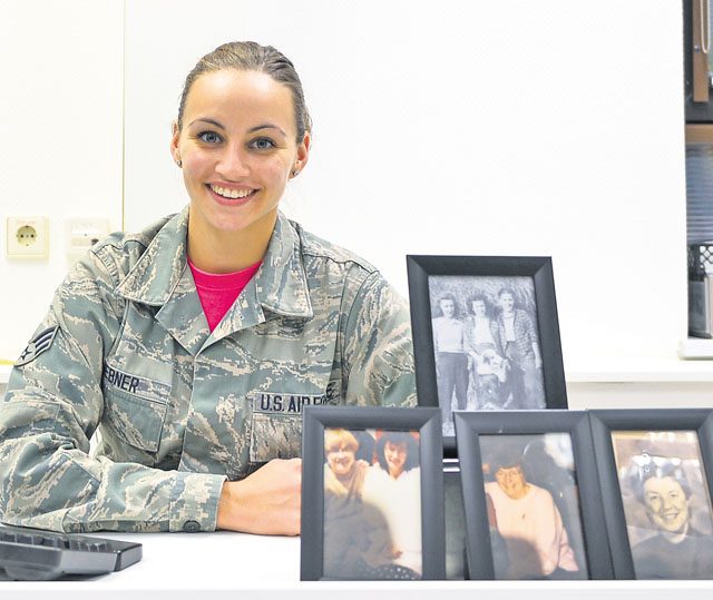 Senior Airman Jordan Hebner, 86th Dental Squadron dental technician, poses with portraits of her grandmother and great-aunts Oct. 14 on Ramstein. Hebner’s grandmother and great-aunts have been affected by breast cancer, which is the second most common cancer for women in the United States.
